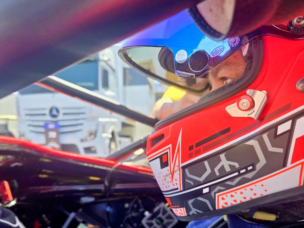 RaceCOM digital radio device and racing headset in a carbon-fiber racecar cockpit